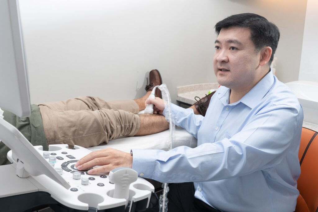 Dr Tay Jia Sheng performing a leg ultrasound for varicose vein assessment