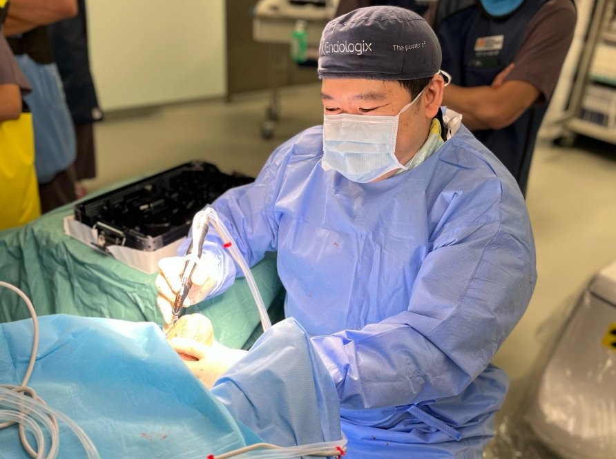 Dr Tay Jia Sheng performing a vascular surgical procedure in theatre