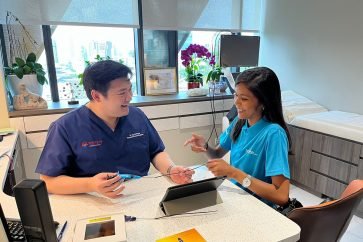 Dr Tay Jia Sheng demonstrating a treatment device during consultation